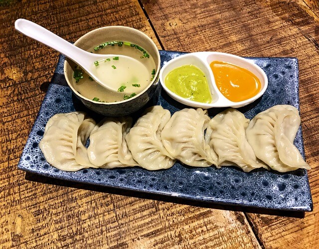 a plate of momo with chutney, a famous street food in Darjeeling