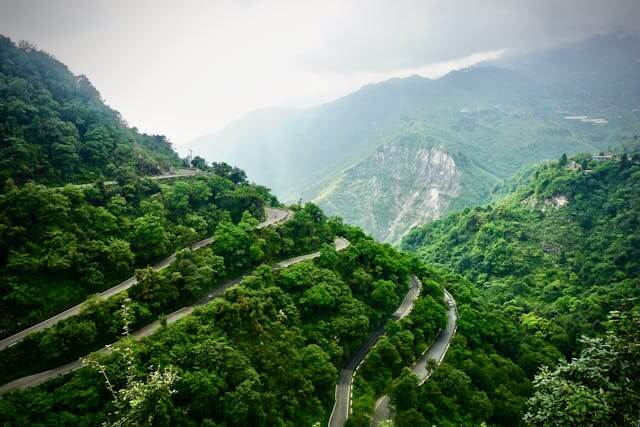 Zig zag road through green hills